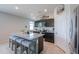 Well-equipped kitchen featuring a granite island with stool seating and stainless steel appliances at 36522 W Santa Monica Ave, Maricopa, AZ 85138