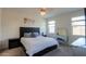 Serene bedroom featuring a plush carpet, large windows, and a stylish vanity table at 36522 W Santa Monica Ave, Maricopa, AZ 85138