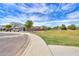 View of the neighborhood featuring a grassy area with a sidewalk near several homes at 36522 W Santa Monica Ave, Maricopa, AZ 85138