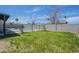 A fenced grassy backyard adjacent to the house at 3722 W Michelle Dr, Glendale, AZ 85308
