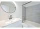 This bathroom features updated fixtures, a modern vanity, and a tub and shower combo with light tile at 3722 W Michelle Dr, Glendale, AZ 85308