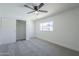 Bright bedroom with neutral carpet, fan and a large window at 3722 W Michelle Dr, Glendale, AZ 85308