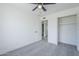 This bedroom features gray carpet, neutral walls, ceiling fan, a closet, and an ensuite bath at 3722 W Michelle Dr, Glendale, AZ 85308