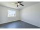 Bedroom with tile floors, a ceiling fan, and a large window at 3722 W Michelle Dr, Glendale, AZ 85308