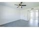 This bedroom showcases gray tile flooring, neutral walls, ceiling fan, and multiple doorways at 3722 W Michelle Dr, Glendale, AZ 85308