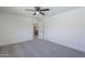 Comfortable bedroom with neutral carpet, fan, and a door to the kitchen at 3722 W Michelle Dr, Glendale, AZ 85308
