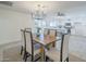 This dining area features a wooden table with seating for six and flows into the open kitchen and living spaces at 3722 W Michelle Dr, Glendale, AZ 85308