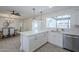 Open kitchen with a breakfast bar that seats four, stainless appliances, modern fixtures, and backyard views at 3722 W Michelle Dr, Glendale, AZ 85308