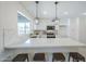 Kitchen with white cabinets and marble counters plus an island with seating and stainless steel appliances at 3722 W Michelle Dr, Glendale, AZ 85308