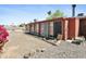 View of the backyard of the home with red exterior and rock landscaping at 3836 W Desert Cove Ave, Phoenix, AZ 85029
