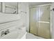 An all-white bathroom with a shower and sliding glass door at 3836 W Desert Cove Ave, Phoenix, AZ 85029