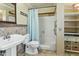 Classic bathroom with a tiled shower, vanity and framed mirror at 3836 W Desert Cove Ave, Phoenix, AZ 85029