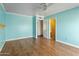 Comfortable bedroom with wood floors, a ceiling fan and a view into an adjacent closet at 3836 W Desert Cove Ave, Phoenix, AZ 85029