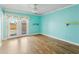 Bright bedroom with wood floors, a ceiling fan and glass patio doors to let in the natural light at 3836 W Desert Cove Ave, Phoenix, AZ 85029