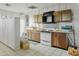 A vintage kitchen with outdated wooden cabinets and white appliances at 3836 W Desert Cove Ave, Phoenix, AZ 85029