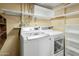 Well-equipped laundry room featuring a modern washer and dryer, with open shelving at 3836 W Desert Cove Ave, Phoenix, AZ 85029