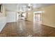 Expansive living area with stone tile, connecting to the kitchen and sunroom, offering versatile space at 3836 W Desert Cove Ave, Phoenix, AZ 85029