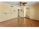 Open living room featuring wood laminate floors, yellow walls, and brick accents at 3836 W Desert Cove Ave, Phoenix, AZ 85029