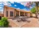 Inviting backyard with covered patio, brick pavers, providing a relaxing outdoor space at 3971 N 151St Ln, Goodyear, AZ 85395