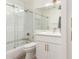 Bathroom featuring a glass-enclosed shower-over-tub with white tiling and vanity with storage at 3971 N 151St Ln, Goodyear, AZ 85395