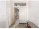 Bright entrance hall with white door, wood floor, carpet and bench at 3971 N 151St Ln, Goodyear, AZ 85395