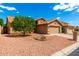 Beautiful single-story home with manicured desert landscaping, a well-kept lawn, and a two-car garage at 3971 N 151St Ln, Goodyear, AZ 85395