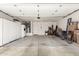 Spacious two car garage with overhead lighting and storage cabinets, providing room for vehicles and storage at 3971 N 151St Ln, Goodyear, AZ 85395