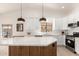 Bright kitchen featuring stainless steel appliances, white countertops, and stylish pendant lighting at 3971 N 151St Ln, Goodyear, AZ 85395