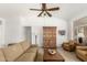 Comfortable living room featuring sofa, ceiling fan, wood floor and art at 3971 N 151St Ln, Goodyear, AZ 85395