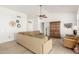 Bright living room boasts neutral tones, ceiling fan, and decorative clocks for a cozy, stylish atmosphere at 3971 N 151St Ln, Goodyear, AZ 85395