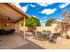 Enjoy outdoor living on this covered patio with pavers, ceiling fan and seating for Gathering and guests at 3971 N 151St Ln, Goodyear, AZ 85395