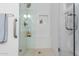 Shower features sleek tile work, glass door and built-in niche, combining style and function at 3971 N 151St Ln, Goodyear, AZ 85395