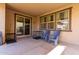 Back patio with windows, blue chairs and dog crates at 4068 E Devon Dr, Gilbert, AZ 85296