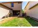 A backyard featuring a partially covered patio and a mix of grassy and dirt areas at 4068 E Devon Dr, Gilbert, AZ 85296