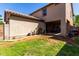 This backyard includes a partially covered patio and some sparse grass at 4068 E Devon Dr, Gilbert, AZ 85296