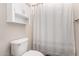Bathroom with white shower curtain and a built in cabinet at 4068 E Devon Dr, Gilbert, AZ 85296