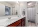 Bathroom with double sinks and a view to the separate toilet and shower room at 4068 E Devon Dr, Gilbert, AZ 85296