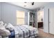 Cozy bedroom featuring cool blue walls, plush carpet and attached bathroom at 4068 E Devon Dr, Gilbert, AZ 85296