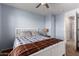 Bedroom with blue walls and carpet, featuring a ceiling fan at 4068 E Devon Dr, Gilbert, AZ 85296