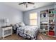 Bedroom with a window, a bookshelf, and blue walls at 4068 E Devon Dr, Gilbert, AZ 85296