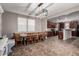 Dining room with connecting view of the kitchen, large windows, and modern lighting at 4068 E Devon Dr, Gilbert, AZ 85296