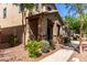 Charming two-story home featuring a cozy front porch with stone accents, and lush desert landscaping at 4068 E Devon Dr, Gilbert, AZ 85296