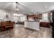 Spacious kitchen flows seamlessly into dining area with stone countertops and modern appliances at 4068 E Devon Dr, Gilbert, AZ 85296