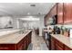 Updated kitchen features stone countertops, stainless appliances, and dark brown cabinets at 4068 E Devon Dr, Gilbert, AZ 85296