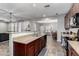 Kitchen bar overlooks a dining area and living room with modern fixtures and finishings at 4068 E Devon Dr, Gilbert, AZ 85296