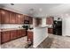 Updated kitchen with stainless appliances, plenty of counter space, and dark wood cabinets at 4068 E Devon Dr, Gilbert, AZ 85296
