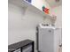 Modern laundry room with storage shelf and brand new white washer and dryer at 4068 E Devon Dr, Gilbert, AZ 85296