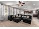 Comfortable living room featuring plush seating, abundant natural light, and seamlessly connects to the modern kitchen at 4068 E Devon Dr, Gilbert, AZ 85296