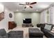 Bright and inviting living room featuring a large TV, comfortable seating, and soft carpet flooring at 4068 E Devon Dr, Gilbert, AZ 85296