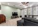 Bright living room with a comfortable seating arrangement, large TV, and soft carpet flooring at 4068 E Devon Dr, Gilbert, AZ 85296